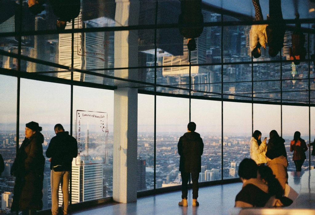 People admire a city's view from a building.